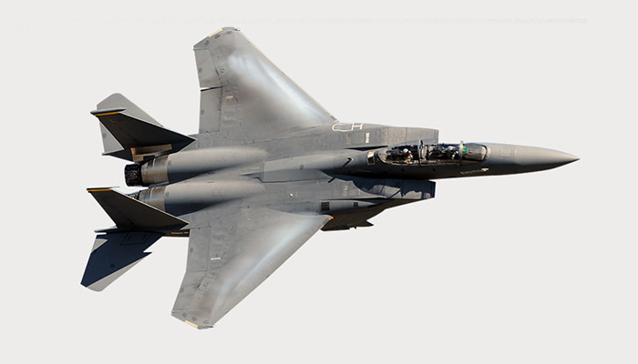 An F-15 Eagle multi-roll fighter making a banking turn.