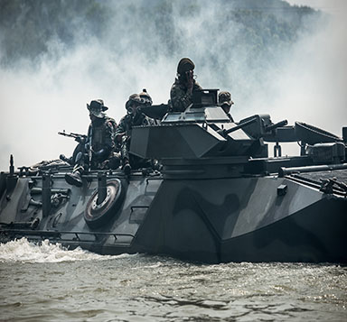 The troops conceal behind the smoke on the tank.