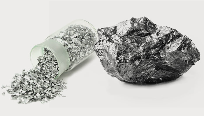 Aluminum in a container next to a rock of aluminum
