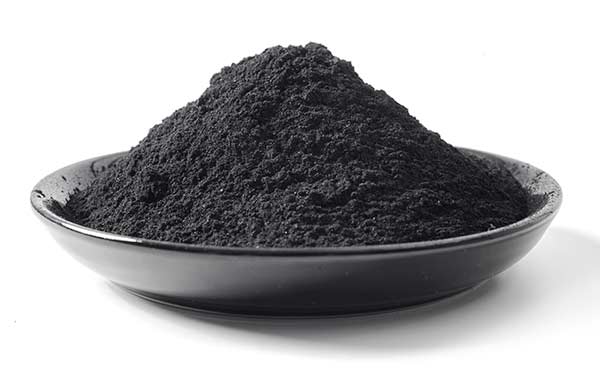 A black bowl containing tantalum powder on a white background.