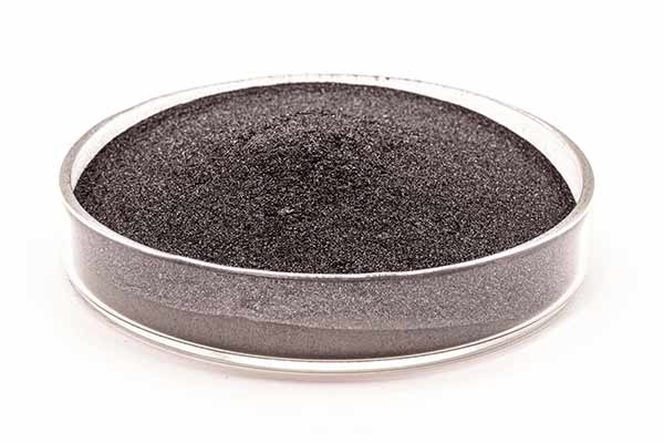 Tungsten powder in a clear, circular glass tray