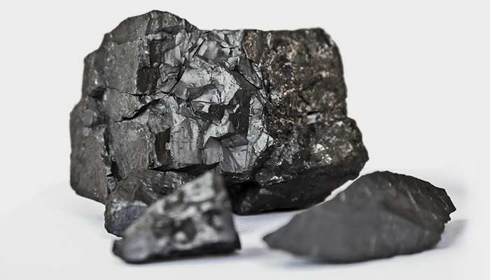Chunks of dark manganese ore on a white background.