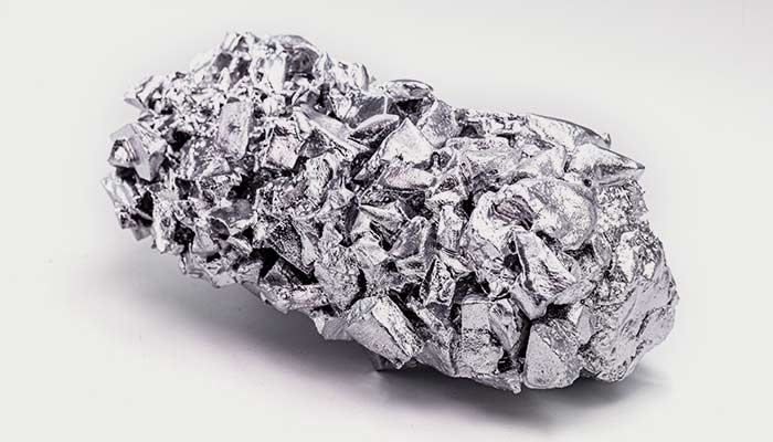A chunk of refined titanium ore on a white background.