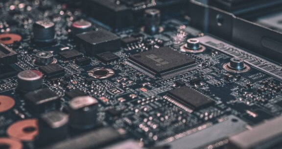 Close-up of a computer motherboard showing integrated circuits, capacitors, and microchips