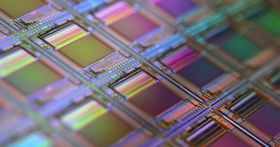 Macro photograph under magnification of an integrated circuit die, showing the metal interconnect layers that make up its circuitry.